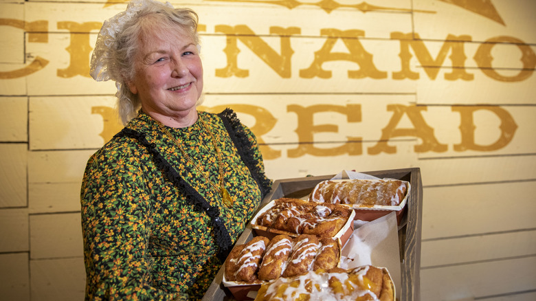 Smiling woman at Silver Dollar City holding cinnamon bread