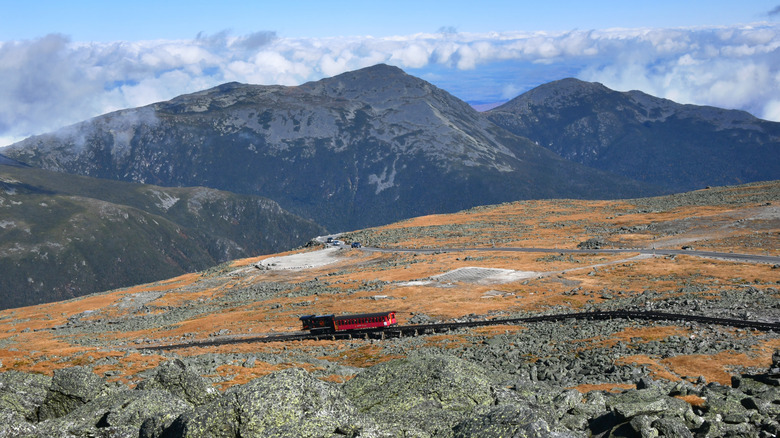 Mount Washington Cog Railway train ascending with mountains in the background