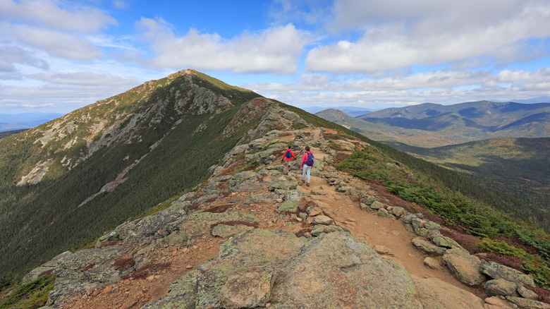 Hikers walking across a Franconia Mountain Ridge Traverse