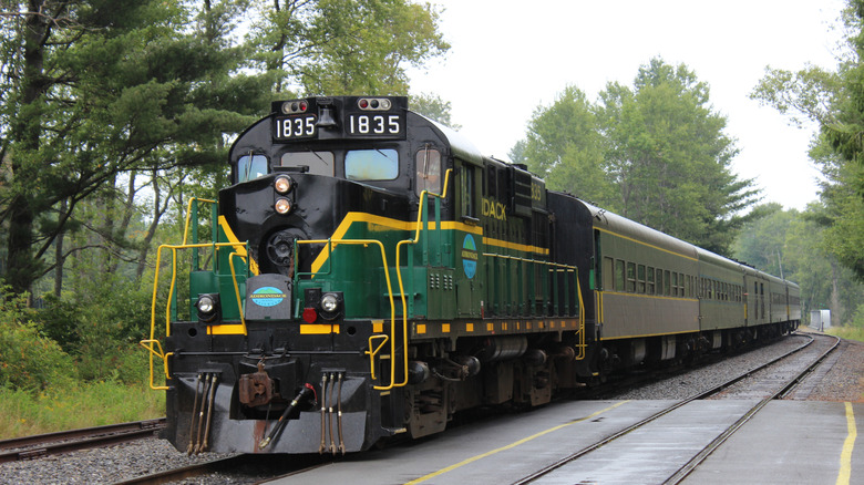 Green Adrinodack railway train going through Adrinodacks
