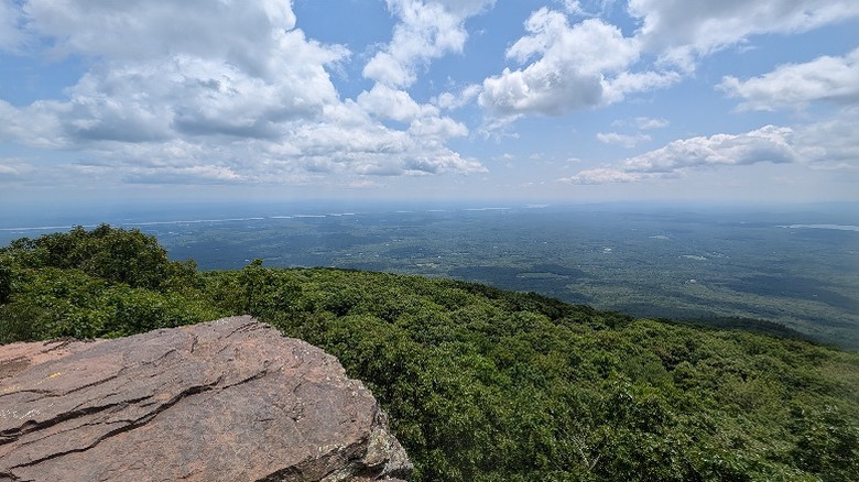 Sweeping view over trees and rivers across the Hudson River Valley from the top of Overlook Mountain.