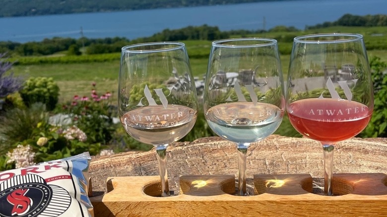 Three glasses and potato chips at Atwater Vineyards in front of lake