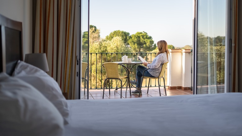 Woma reading a book on the hotel terrace