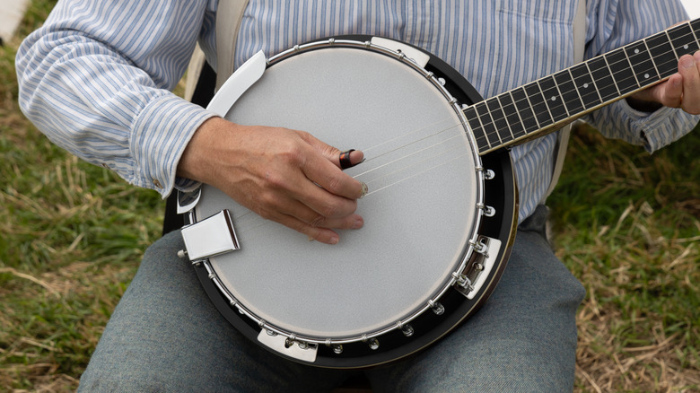 Close up of a person playing a banjo