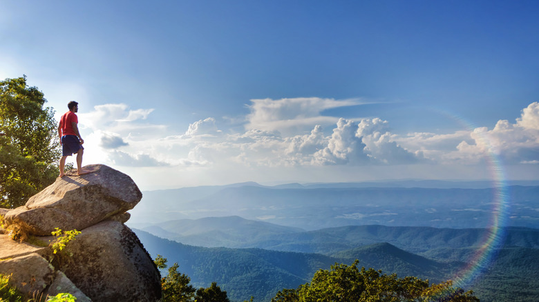 Hiker on a rock overlooking the Blue Ridge Mountains