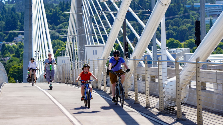 Family riding bikes on a bridge over the Willamette River