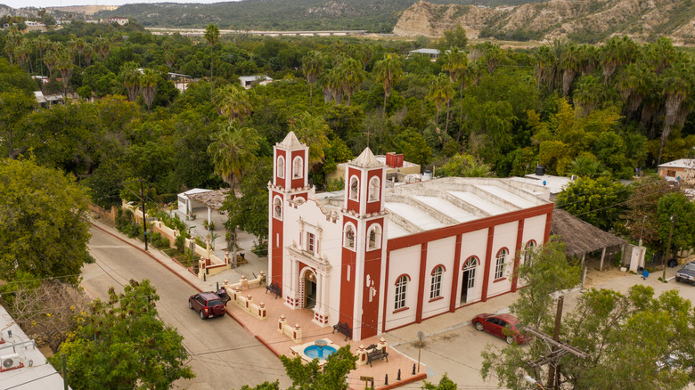 Misión church in Santiago town center, surrounded by palm trees