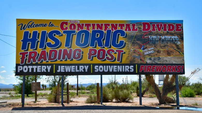 A billboard advertising a Continental Divide historic trading post