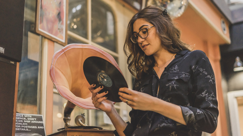 Woman holding a record in an antique store