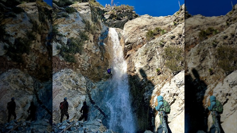 Four canyoneers rappelling down San Antonio Falls, San Gabriel Mountains, CA.