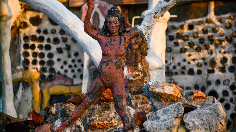 Small sculpture of Indigenous figure with rocks and building in Thunder Mountain Monument Nevada