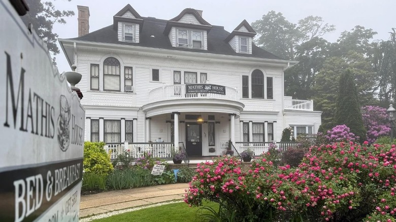 Mathis House on foggy day with beautiful flower garden outside