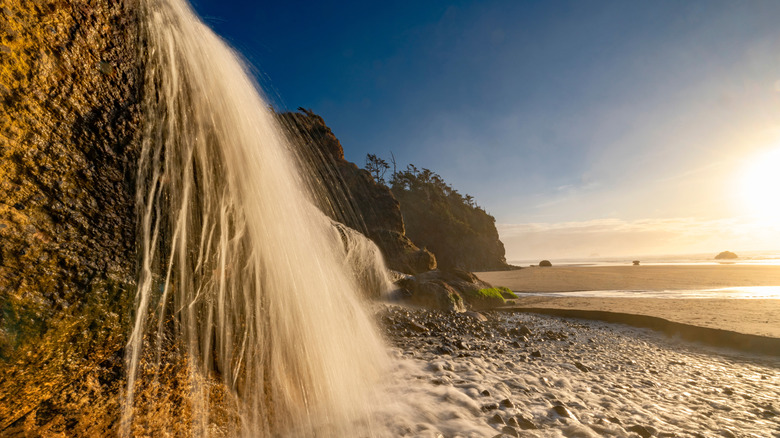 Hug Point Falls crashes into the beach and into the Pacific