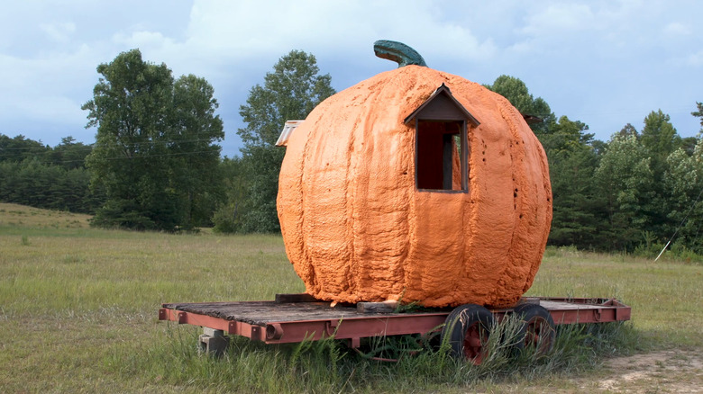 A giant pumpkin with a window in a field in Pumpkintown, South Carolina