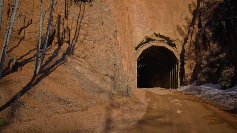 Dirt road going into a Gold Camp Road Tunnel in Colorado
