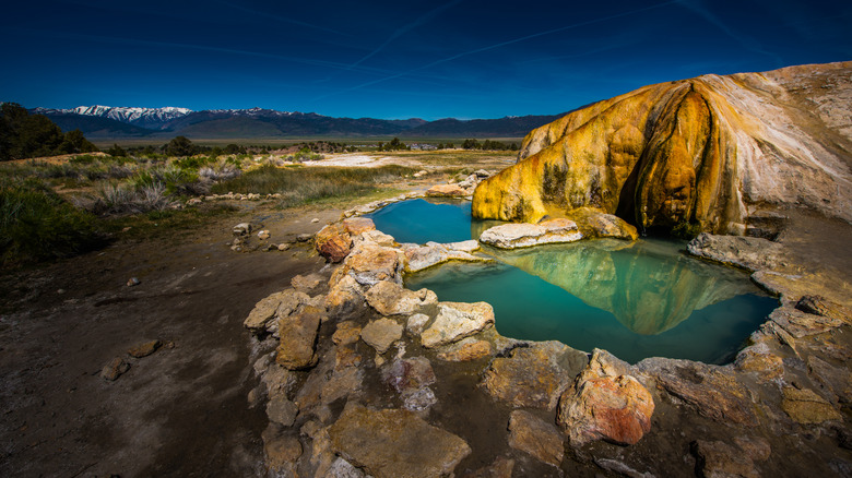 Two turquoise hot springs overlook the Sierra Nevada at Travertine Hot Springs