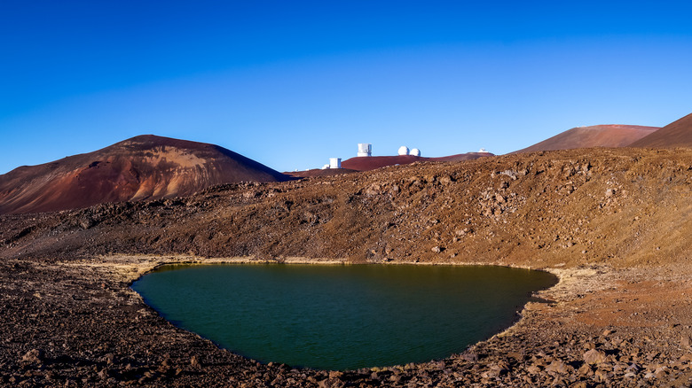 Volcanic lake with buildings in background