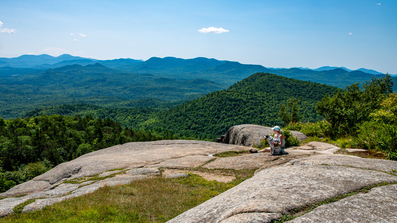 Woman and dog on Poke-O-Moonshine Moutain in New York's Adirondacks