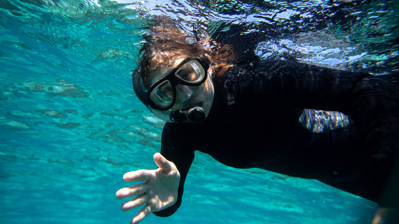 Woman snorkeling in Hopkins, Belize