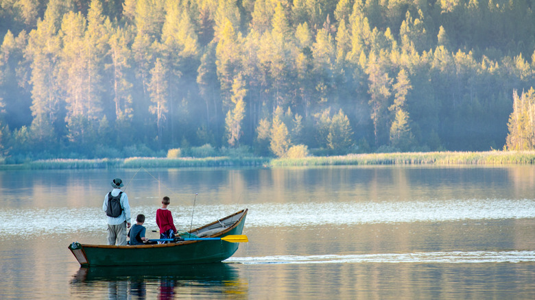 A family fishing on a boat in Horsethief Reservoir.
