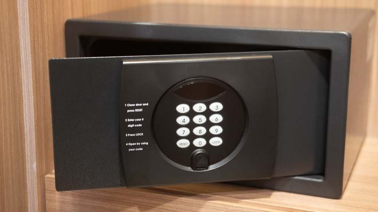 Slightly open black safe box in a hotel room closet