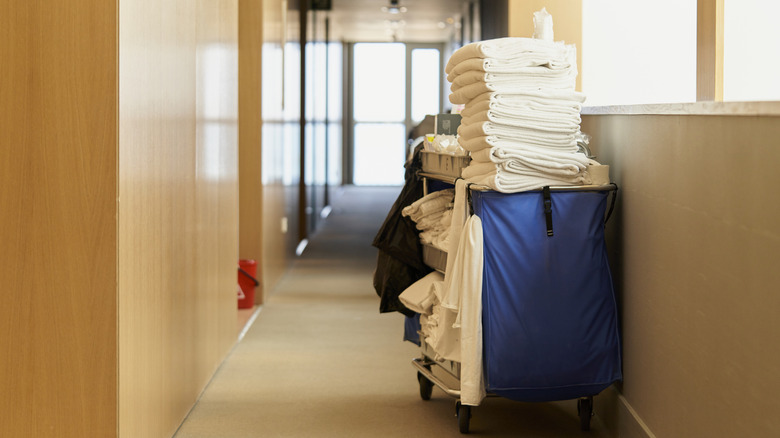 Blue housekeeping cart in the hallway of a hotel.