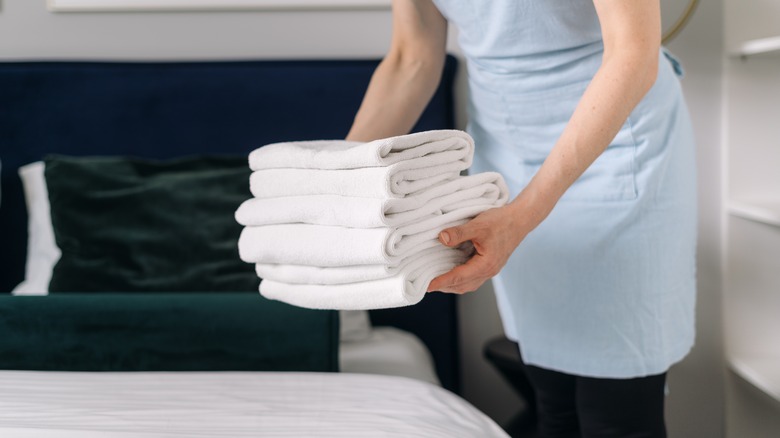 A housekeeper replacing clean towels