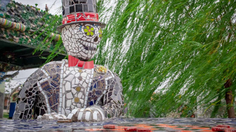 A mosaic sculpture of a skeleton in a top hat in Smither Park, Houston