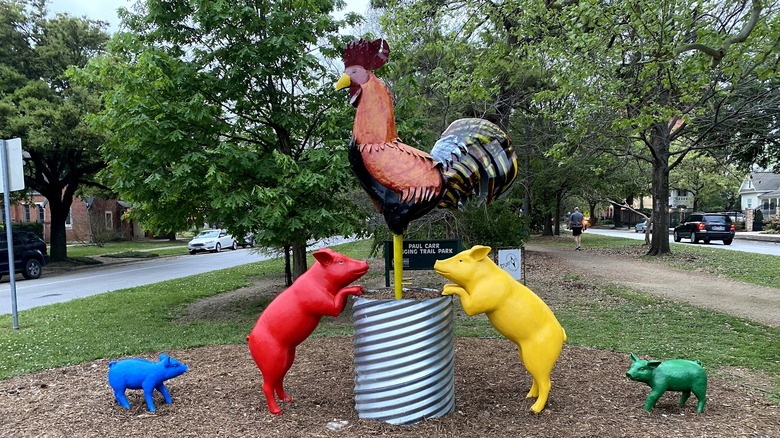 Sculpture with colorful pigs and a rooster on Heights Boulevard, Houston Heights, Texas