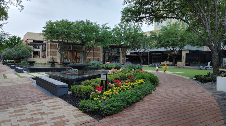 View of walkways and flowers in the Town & Country Village mall in Houston