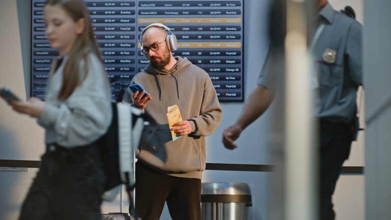 Traveler at the airport checking their phone