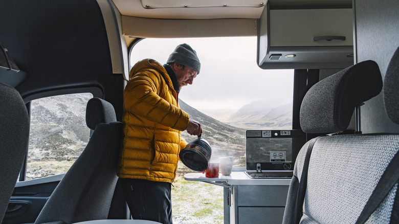 A person brewing coffee in RV