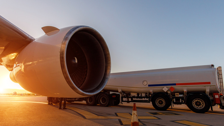 A fuel truck refueling an airplane