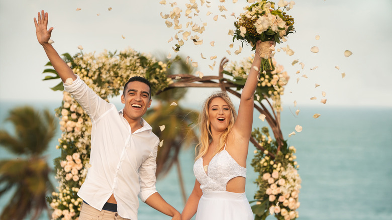 A couple at their beach wedding