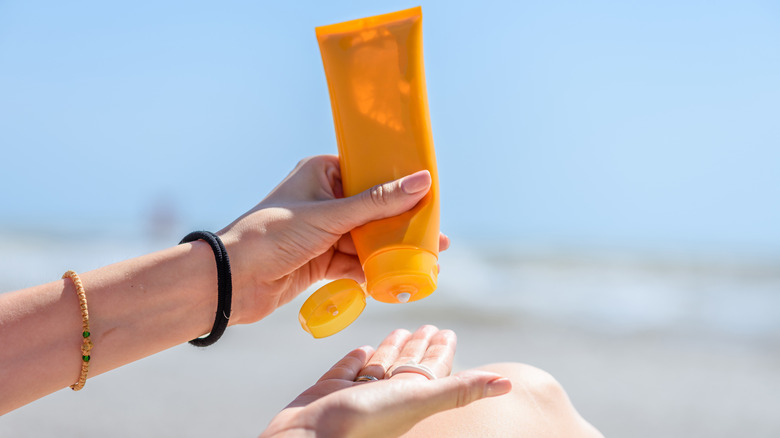 Person using sunscreen at beach