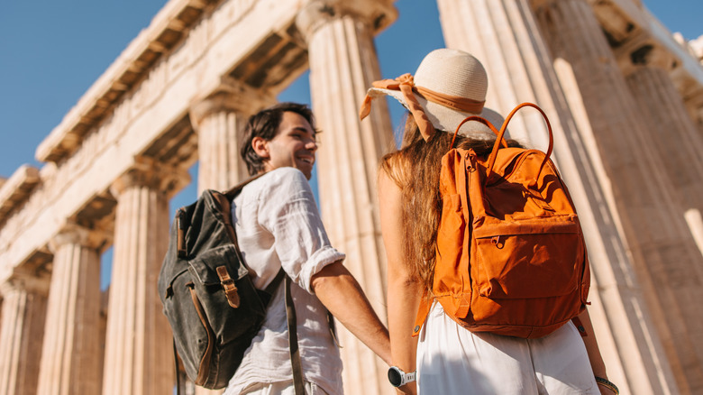 Couple walking toward the Parthenon in Athens.