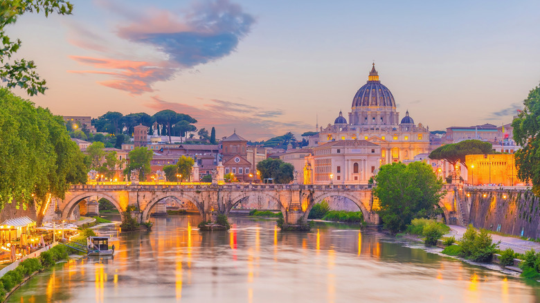St. Peter's Basilica in the Vatican, Rome, Italy seen from across the river at sunset