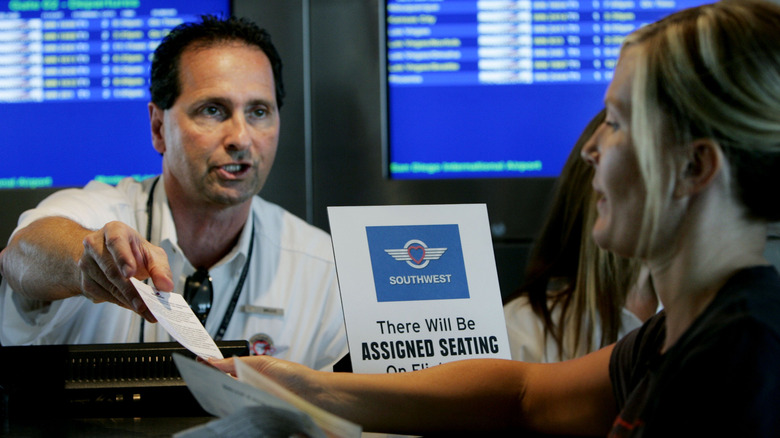 A Southwest Airlines ticket agent talking to a passenger