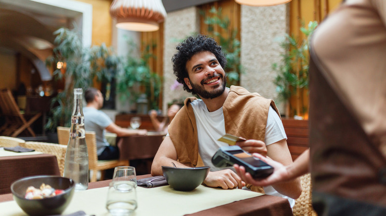 Man paying for restaurant food with credit card