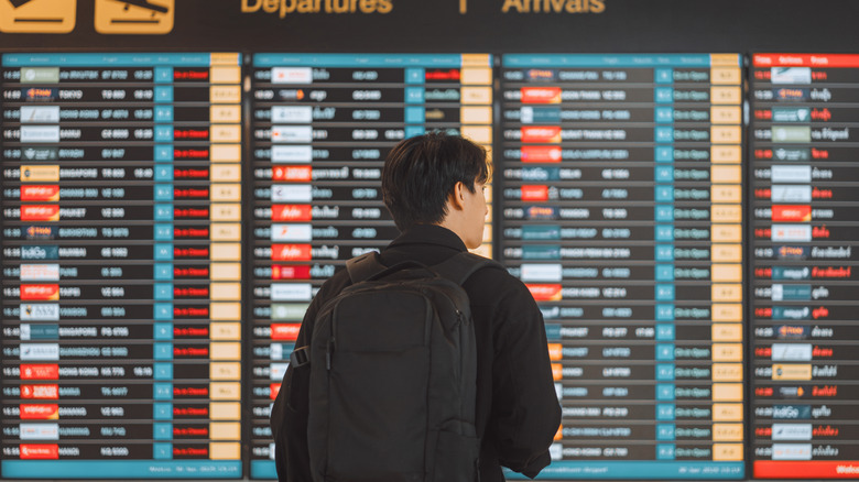 Man looking at departure board