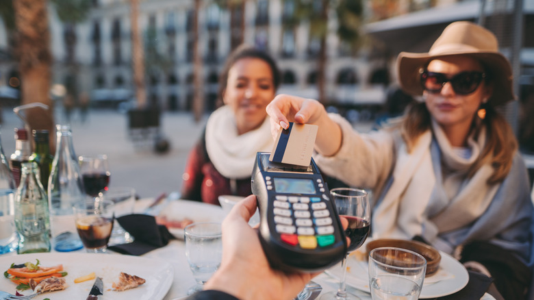 Woman paying for food with credit card