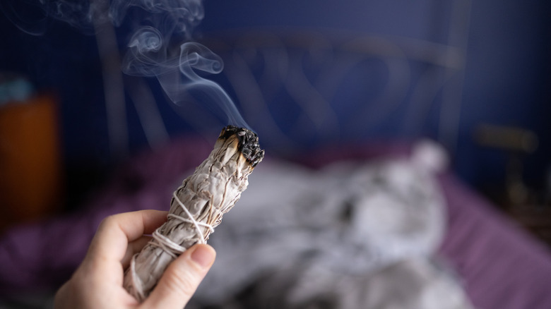 Someone smudging with a sage stick