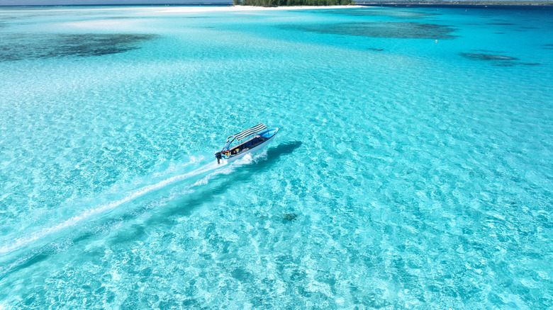 Boat speeding across clear water