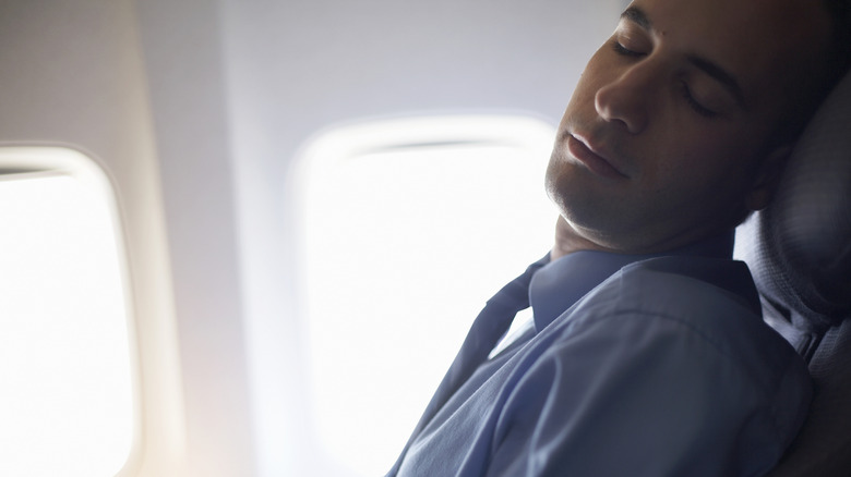 Sleeping man on plane