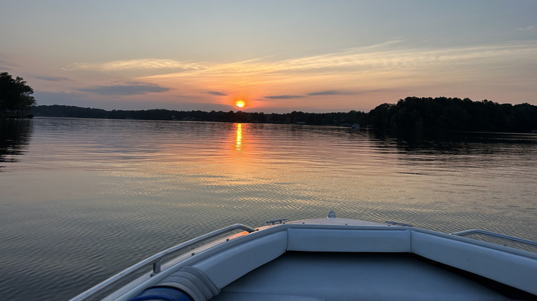 A boat on calm water during sunset on Hyco Lake in the Piedmont region of North Carolina
