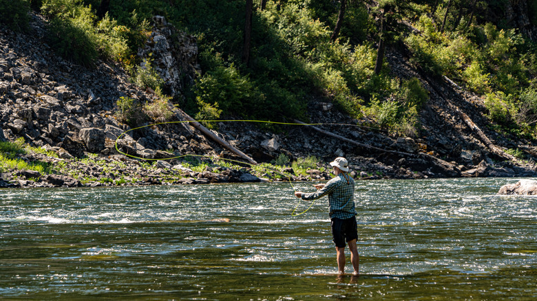 Hiker fly fishing on the Salmon River, ID