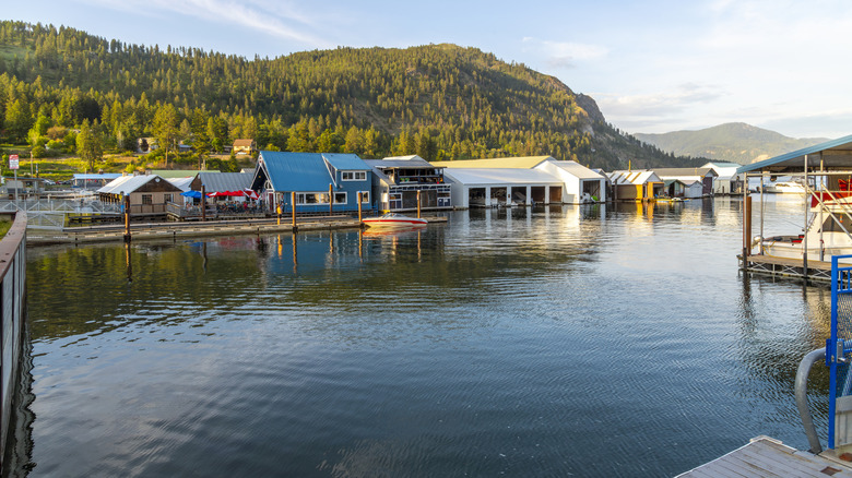 Floating home and boathouses with mountains in background on Lake Pend Orielle