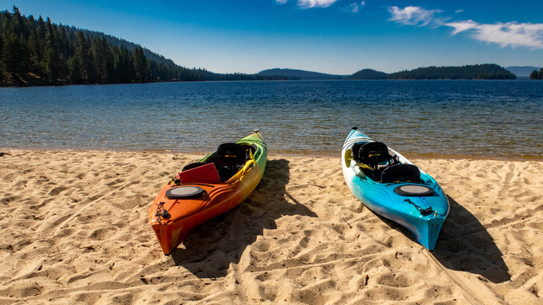 Kayaks on beach along shore of Payette Lake