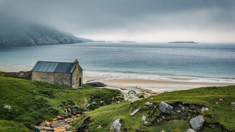 An old stone house against the sea backdrop of an Irish island