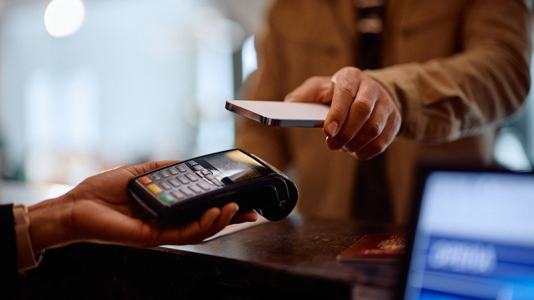 Man using a smartphone to pay a bill